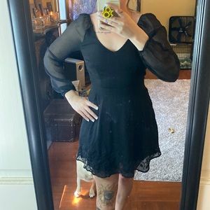 Mini, black, sheer arms, floral embroidery along bottom.